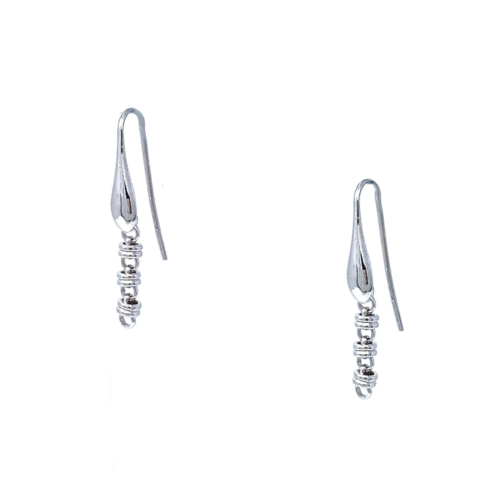A closeup of silver chain earrings designed and hand-crafted by DelBrenna Italian Jewelers in Tuscany. The earrings are designed based on the iconic Links collection of DelBrenna silver chains, necklaces, rings, and bracelets.