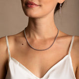 A model wearing a short (16-inch) DelBrenna Iconic Links 3mm silver necklace with matching Links 3mm large silver hoop earrings. Both pieces of hand-crafted Italian jewelry are made by DelBrenna Italian Jewelers in Tuscany. 