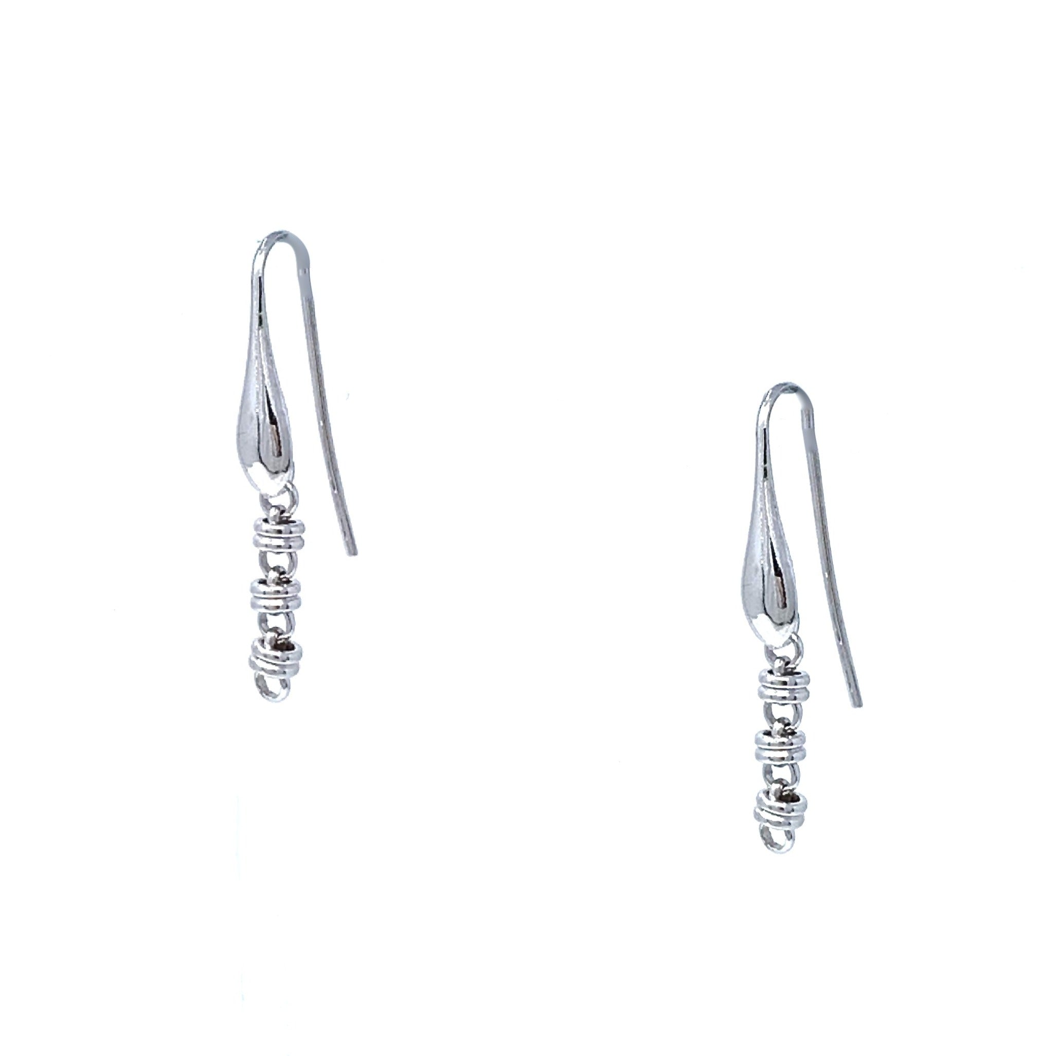 A closeup of silver chain earrings designed and hand-crafted by DelBrenna Italian Jewelers in Tuscany. The earrings are designed based on the iconic Links collection of DelBrenna silver chains, necklaces, rings, and bracelets. 