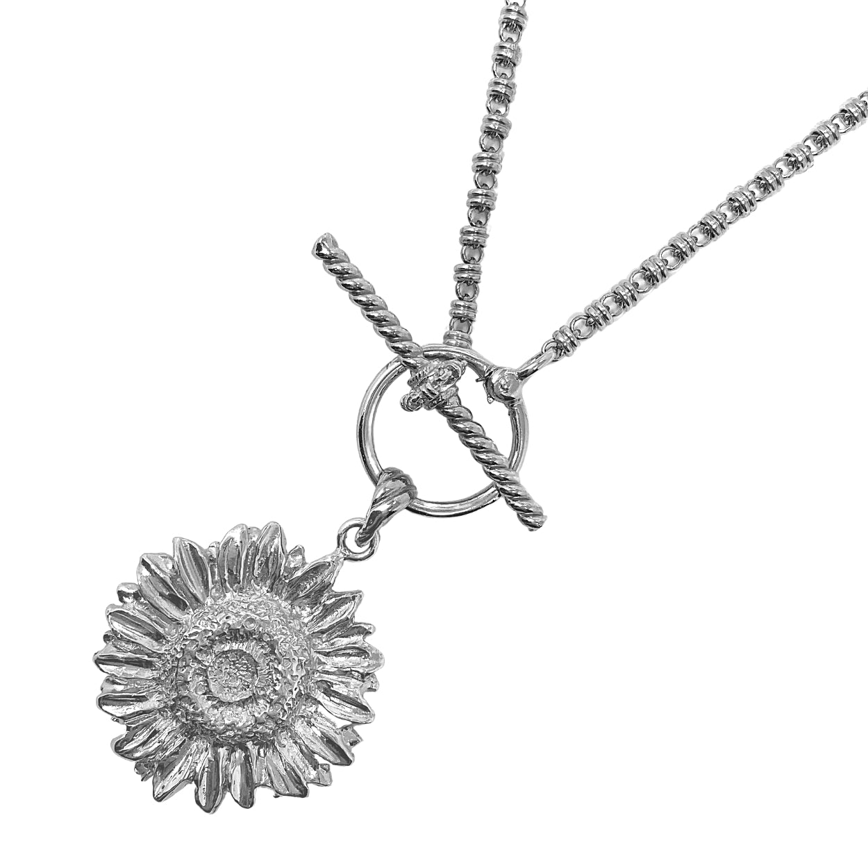 A closeup of the silver toggle clasp with an attached silver sunflower pendant on a silver necklace - the silver chain is from the Links 3mm collection from DelBrenna Italian Jewelry designers and artisans. Hand-crafted in Tuscany.